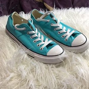 Turquoise/blue converse sneakers.